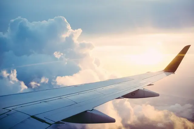 Aircraft wing above clouds — illustration of air freight